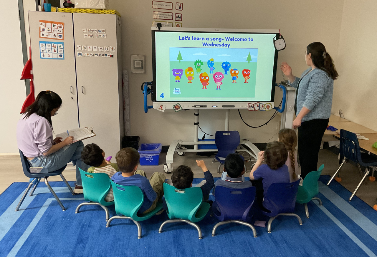 kids in classroom playing with musical instruments